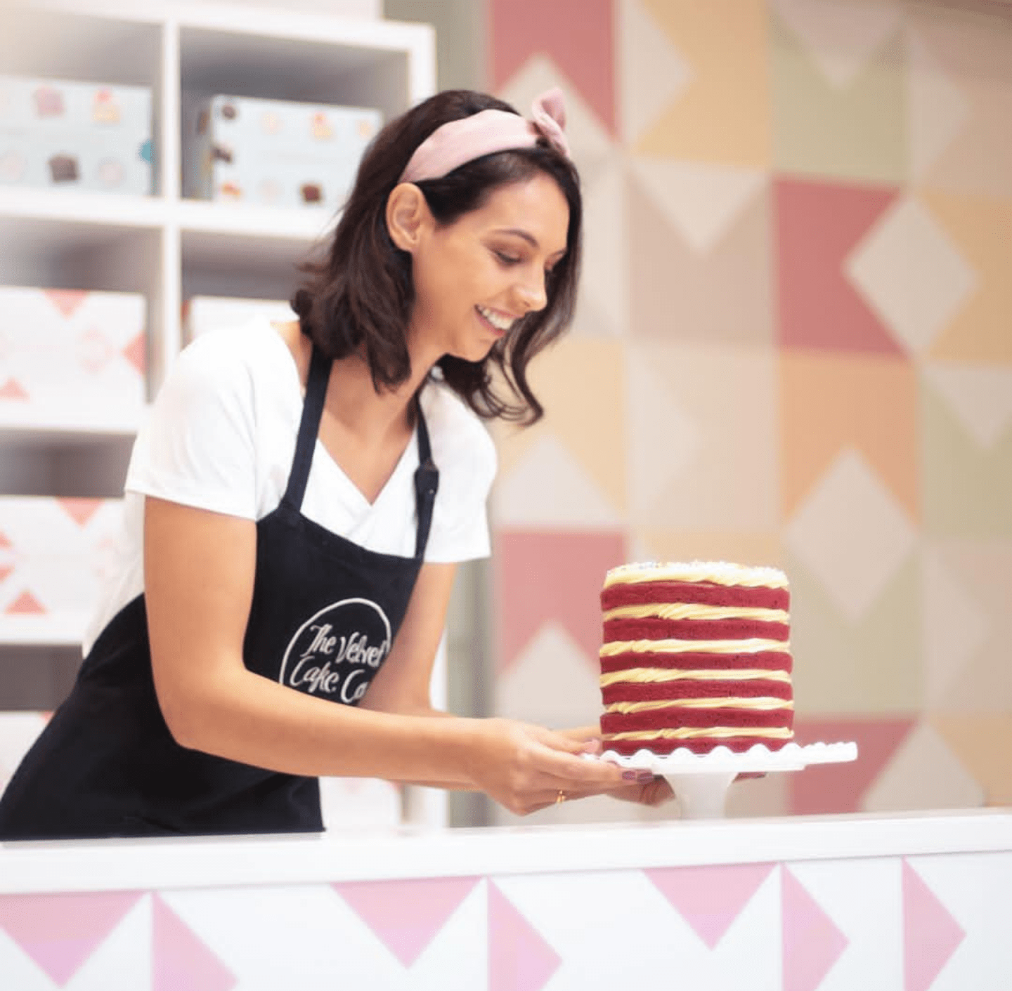A girl holding a cake
