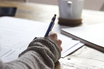 person writing in a notebook