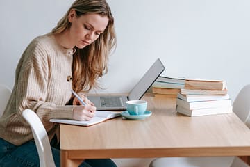 woman writing in a notebook